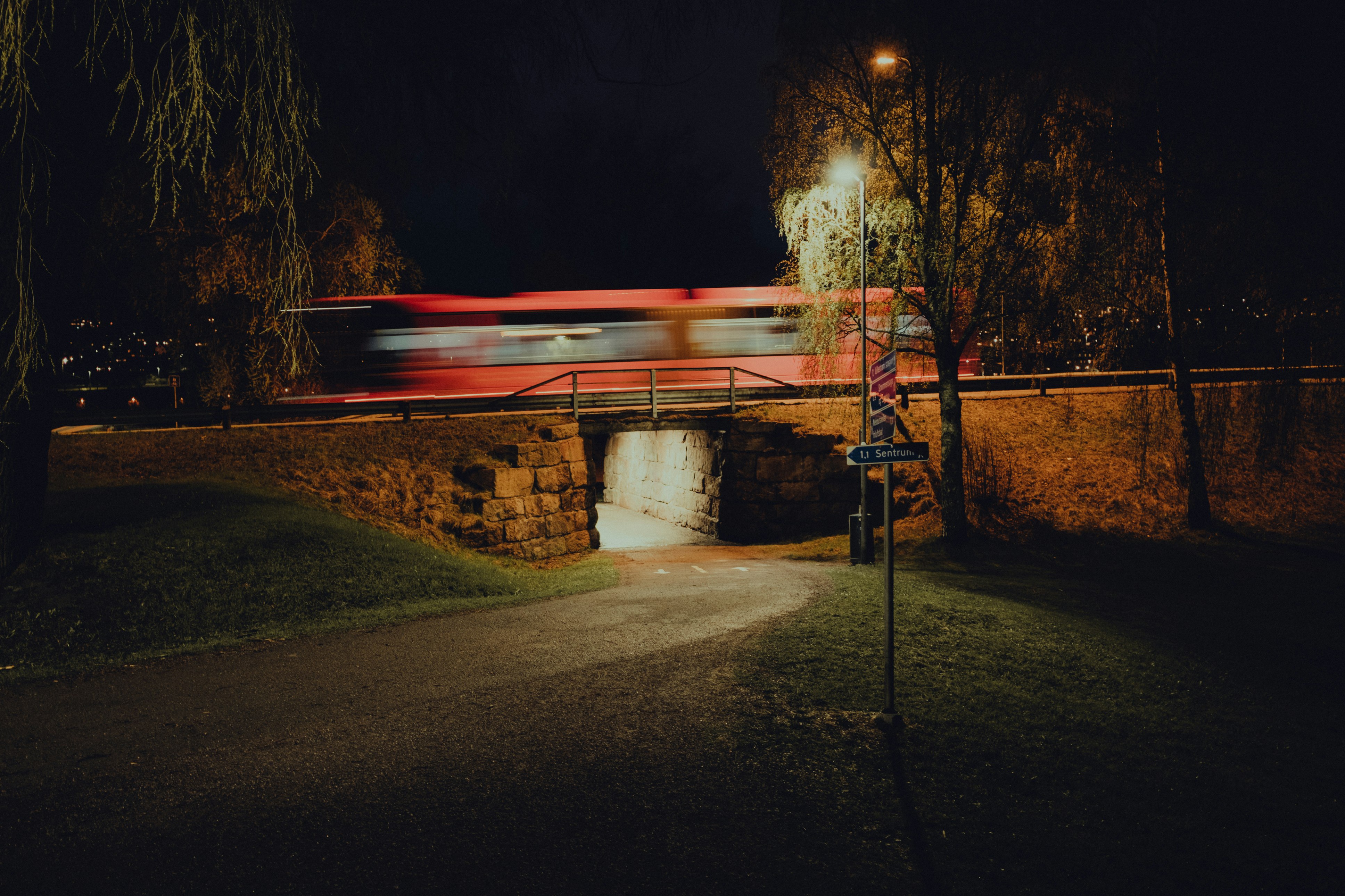 red light on gray concrete bridge during night time